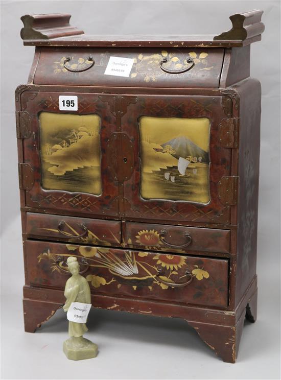A Japanese lacquered table cabinet and a bowenite carving of Kwan Yin (2)